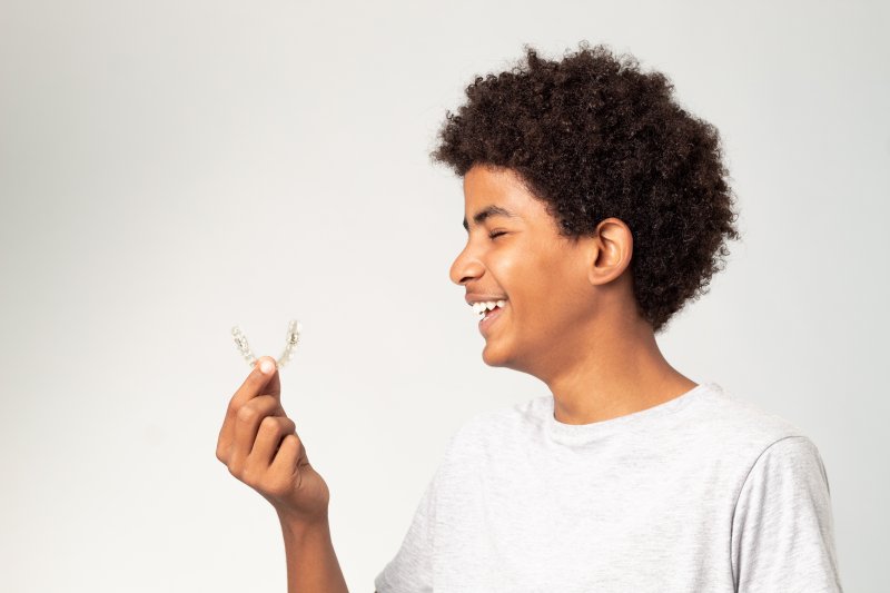 Teen admires his clear aligner