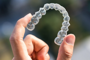 Close up of patient holding a clear aligner